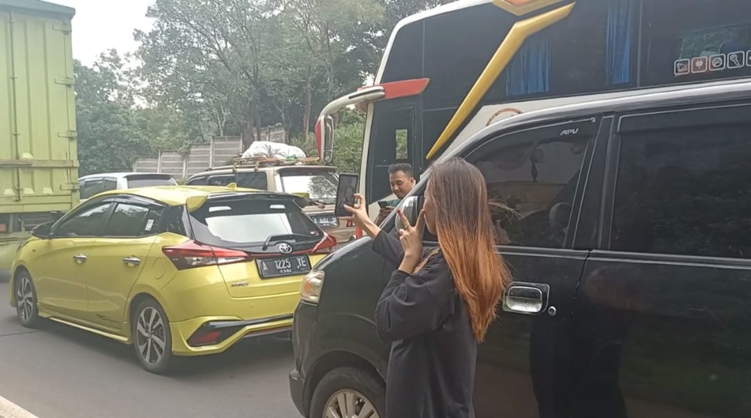 Hibur Diri Karena Kemacetan, Pemudik Ini Asik Foto Selfie di Tol. (Foto: MNC Media)