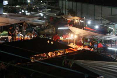 Pedagang dan pembeli beraktivitas di Pasar Kramat Jati, Jakarta Timur, Sabtu (27/2/2021) malam.