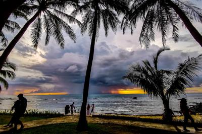 Pengunjung menikmati keindahan panorama matahari terbenam di Pantai Anyer, Serang, Banten, Sabtu (27/3/2021).
