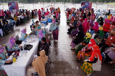 Tim medis dan peserta vaksinasi berpakaian baju adat mengikuti Festival Smart Vaksinasi Makassar di Makassar, Sulawesi Selatan, Kamis (1/4/2021).