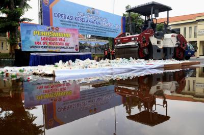 Polisi memusnahkan ribuan barang bukti minuman keras pada hari pertama puasa Ramadan, di halaman Mapolrestabes Surabaya, Jawa Timur, Selasa (13/4/2021).