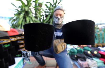 Penjual merapikan peci di kawasan Cillitan, Jakarta Timur, Selasa (20/4/2021).