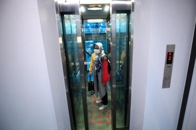 Penumpang Transjakarta saat menggunakan lift di JPO Jembatan Gantung, Daan Mogot, Jakarta Barat, Sabtu (29/5/2021).