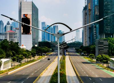 Suasana Jalan Sudirman terlihat lengang pada hari kedua PPKM darurat di Jakarta Pusat, Minggu (4/7/2021).