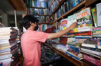 Pedagang menata buku di salah satu kios buku di kawasan Kwitang, Jakarta Pusat, Minggu (11/7/2021).