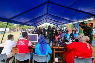 Warga antre untuk mengikuti vaksinasi Covid-19 keliling di RPTRA Kalijodo, Jakarta Barat, Minggu (11/7/2021).