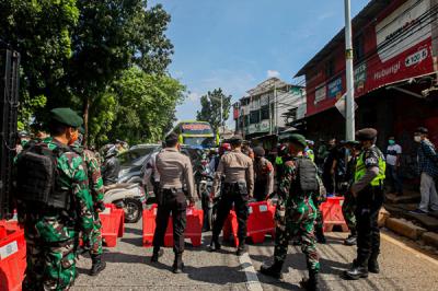 Petugas saat memeriksa kelengkapan warga yang ingin melintas di pos penyekatan PPKM Darurat Lenteng Agung, Jakarta Selatan, Jumat (16/7/2021).