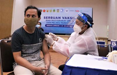 Petugas menyuntikan vaksin kepada Warga saat Serbuan Vaksinasi di GOR Widya Dirgantara, Seskoau, Lembang, Bandung, Rabu (21/7/2021).