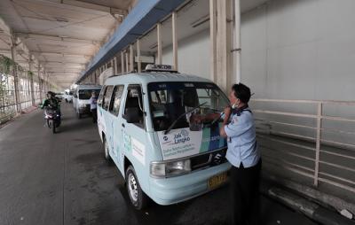 Supir angkutan Jak Lingko mengenakan masker saat menunggu penumpang di Tanah Abang, Jakarta, Kamis (22/7/2021).