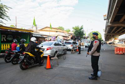 Petugas melakukan pemeriksaan Surat Tanda Registrasi Pekerja kepada pengendara yang melewati penyekatan di Pos Lampiri, Kalimalang, Senin (2/8/2021).