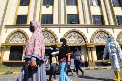 Pasien Covid-19 beraktifitas didalam kamar ketika menjalani isolasi di gedung isolasi Hotel Asrama Haji (HAH) Surabaya, Jawa Timur, Selasa (17/8/2021).