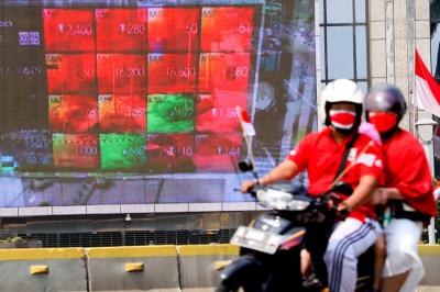 Pengendara saat melintas berlatar belakang tampilan iklan di gedung Bursa Efek Indonesia, Selasa (17/8/2021).