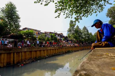 Warga mengikuti lomba mancing sambil berjemur dengan protokol kesehatan dalam rangka HUT Kemerdekaan ke-76 di Kali Grogol, Jakarta Barat, Selasa (17/8/2021).