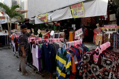 Calon pembeli melihat-lihat baju di salah satu pertokoan di kawasan Pasar Baru, Jakarta, Kamis (19/8/2021).