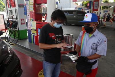 Petugas melayani pembayaran non tunai di Spbu Coco Jemursari Surabaya, Jawa Timur, Kamis (19/8/2021).