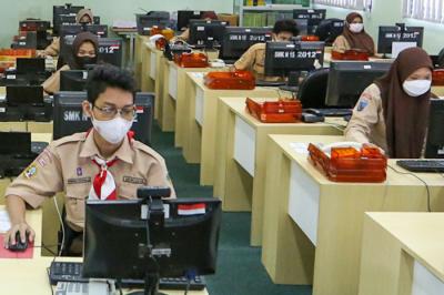 Guru pengajar saat mengawasi pelaksanaan Asesmen Nasional Berbasis Komputer (ANBK) 2021 di SMK 15, Jakarta, Rabu (22/9/2021).