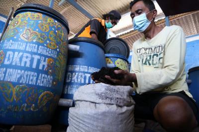 Warga menyelesaikan produksi kompos organik di rumah kompos Kampung Berseri Astra (KBA), Keputih Tegal Timur Surabaya, Jawa Timur, Selasa (28/9/2021).