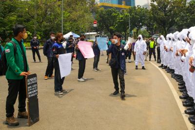 Mahasiswa membentangkan poster saat melakukan aksi unjuk rasa di kawasan Monas, Jakarta, Rabu, (6/10/2021).