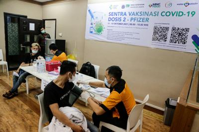 Vaksinator menyuntikkan vaksin Covid-19 jenis Pfizer kepada warga di Sentra Vaksinasi Dosis 2 MNC Peduli, MNC Center, Jakarta Pusat, Senin (11/10/2021).