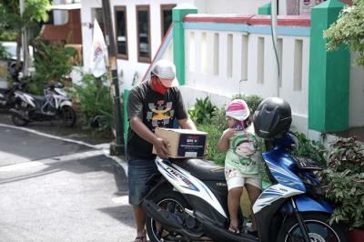 Perwakilan GoTo didampingi tim SalamAid, Ketua RW dan tim relawan, menyerahkan paket sembako pada warga di kawasan Semarang Tengah.