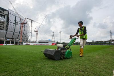 Petugas saat melakukan perawatan lapangan latihan Jakarta International Stadium (JIS) di Tanjung Priok, Jakarta Utara, Selasa (7/12/2021).
