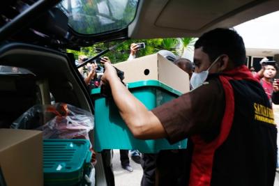 Petugas Kejaksaan Tinggi (Kejati) Sulsel membawa kontainer berisi dokumen dan arsip di Kantor Perusahaan Air Minum Daerah (PDAM) Makassar, Kamis (9/12/2021).