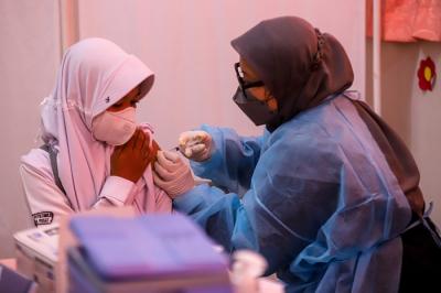 Tenaga kesehatan menyuntikkan vaksin Covid-19 kepada pelajar di SDN Cempaka Putih Timur 03, Jakarta Pusat, Selasa (14/12/2021).