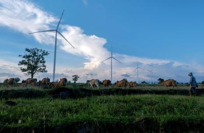 Warga beraktivitas di sekitar baling baling raksasa Pembangkit Listrik Tenaga Bayu (PLTB) Tolo, Kabupaten Jeneponto.