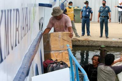 Anak buah kapal ojeg tradisional tujuan Kaliadem kepulauan seribu mengangkut logistik yang akan diangkut ke dalam kapal atau ojeg di Pelabuhan Kali Adem.