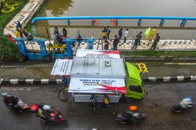 Uji coba layanan bergerak mobil pompa menyedot air di Kolam Retensi Simpang Polda Palembang, Jumat (7/1/2022).