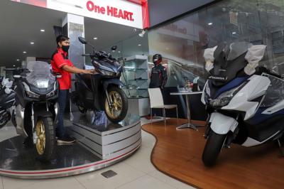 Petugas membersihkan sepeda motor yang di panjang di salah satu dealer motor di kawasan Pasar Minggu, Jakarta Selatan, Senin (10/1/2022).