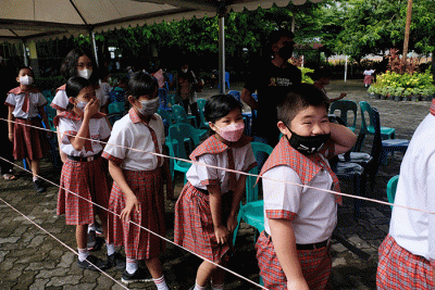 Petugas kesehatan menyuntikan vaksin Covid-19 kepada anak saat mengikuti 'Road Show' vaksin Covid-19 bagi anak usia 6-11 tahun di SD Kristen Hati Kudus.
