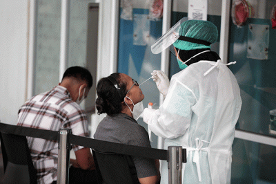 Petugas melakukan tes usap PCR kepada warga di laboratorium Genomik Solidaritas Indonesia (GSI), Jakarta, Kamis (3/2/2022).