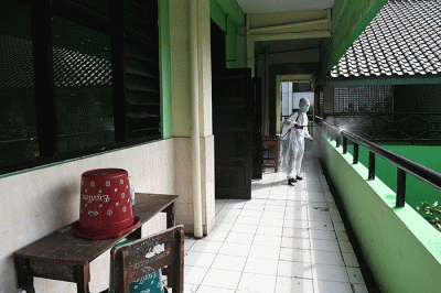 Petugas PMI Jakarta Pusat menyemprotkan cairan disinfektan di SMPN 4, Jakarta, Jumat (4/2/2022).