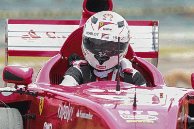 Michael Latip pembuat replika mobil balap F1 saat berpose layaknya pembalap di kawasan Sirkuit Mandalika, Lombok Tengah, NTB, Minggu (13/2/2022).