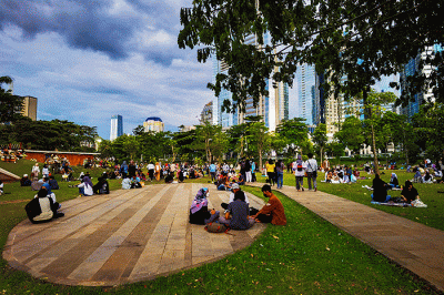 Warga mengisi libur akhir pekan dengan menikmati senja di hutan kota Kawasan Gelora Bung Karno, Jakarta, Minggu (20/3/2022).