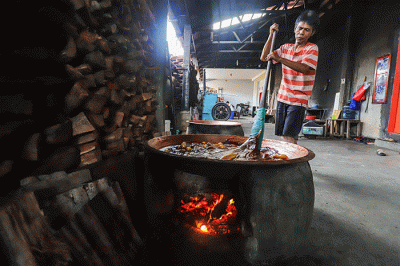Pekerja mengaduk dodol dalam kuali di rumah produksi Dodol Betawi Sari Rasa Ibu Yuyun, Jakarta Selatan, Rabu (30/3/2022).