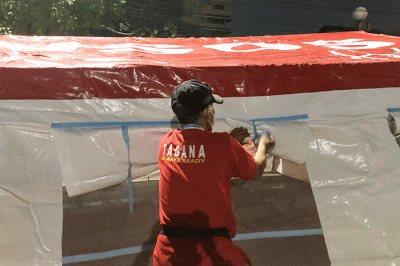 Petugas pemadam kebakaran bersama petugas Palang Merah Indonesia mendirikan tenda darurat untuk warga yang menjadi korban kebakaran di kawasan Pasar Gembrong.