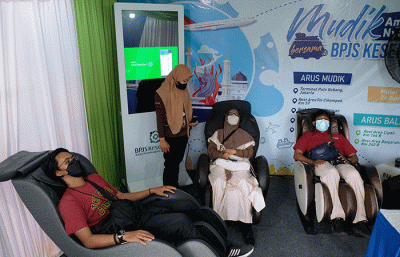 Sejumlah pemudik beristirahat menggunakan kursi pijat posko mudik BPJS Kesehatan di Pelabuhan Soekarno Hatta, Makassar, (26/4/2022).