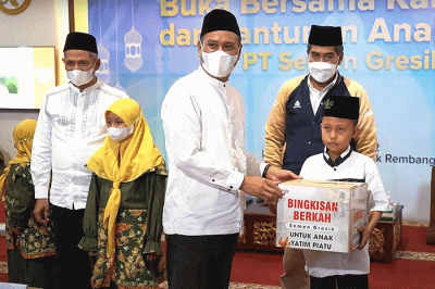 Direktur Utama PT Semen Gresik, Subhan (tengah) menyerahkan bingkisan berkah kepada anak yatim piatu di Rembang, Jawa Tengah.
