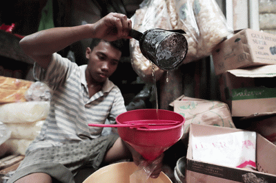Pedagang mengemas minyak goreng curah di Pasar Kecapi, Kota Bekasi, Jawa Barat, Rabu (18/5/2022).