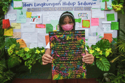 Sejumlah siswa menempelkan tulisan sebuah harapan untuk ekosistem lingkungan pada mading sekolah di kompleks SD Negeri Pekunden Semarang, Jawa Tengah.