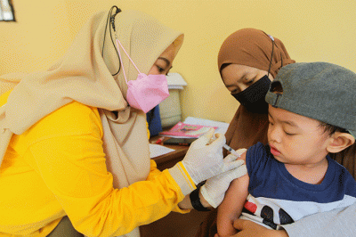 Petugas saat memberikan suntikan dosis vaksin Campak-Rubela pada balita dalam program Bulan Imunisasi Anak Nasional di RPTRA Kebon Pala, Jakarta Timur.