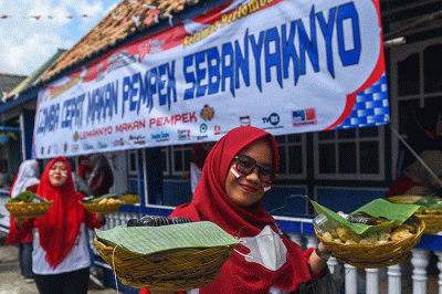 Peserta lomba makan pempek adu kuat dan cepat makan sebanyak 40 buah pempek berbagai jenis di Kampung Kreatif Pempek Tanggo Rajo Cindo.