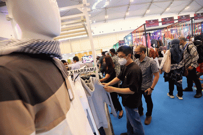 Pengunjung mengamati baju yang dipamerkan saat Jakarta Muslim Fashion Week (JMFW) 2023 di ICE, BSD City, Banten, Kamis (20/10/2022).