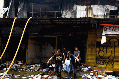 Sejumlah pedagang mencari kembali barang-barang yang masih tersisa akibat terbakar sebanyak 20 kios di Pasar Pagi Asemka, Jakarta, Jumat (18/11/2022).