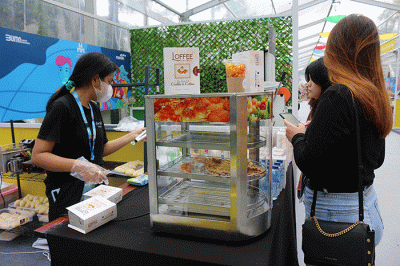 Pengunjung memesan menu makanan di Loffee Croffle & Coffe di pameran Wirausaha Muda Mandiri (WMM) Fest 2022 di Plaza Barat Senayan, Jakarta, Sabtu (10/12/2022).