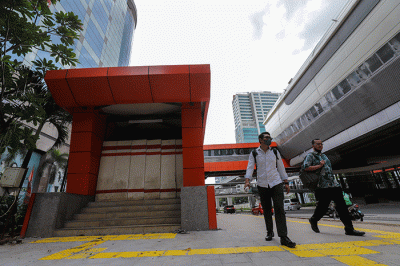 Warga melintas didekat proyek Stasiun Lintas Raya Terpadu (LRT) Rasuna Said, Kuningan, Jakarta Selatan, Rabu (14/12/2022).