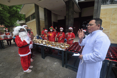 Ibu-ibu relawan Piring Kasih berbagi makan siang gratis kepada masyarakat di pelataran Gereja St Theresia Bongsari Semarang, Jawa Tengah, Kamis (22/12/2022).
