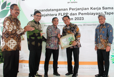 Direktur Consumer Bank BTN Hirwandi Gafar (kedua kanan) menunjukkan naskah perjanjian kerja sama penyaluran KPR Sejahtera FLPP dan Pembiayaan Tapera.